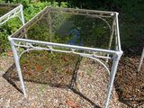a glass table with a metal frame on it