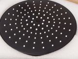 a black plate with white dots on it in a box