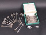 a lot of forks and spoons in a green box