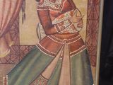 an old picture of a woman in a green and red dress