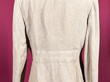 the back view of a beige suit on a mannequin mannequin