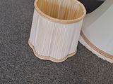 a lamp that is sitting on the floor next to a trash can