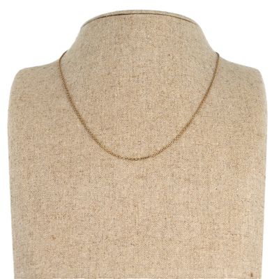 a mannequin torso with a gold chain on it