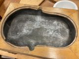 a wooden table with a metal bowl on it