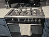 a black stove top oven sitting in the middle of a kitchen