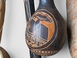 many different types of pottery displayed on the wall