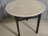 a white table with a black legs and a white table top