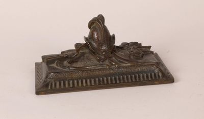 a bronze figurine of a woman sitting on a bench