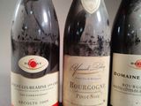three bottles of wine are lined up on a table