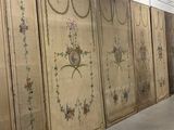 a room that has a wall with a bunch of paintings on it