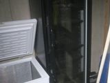 a refrigerator and a freezer sitting in a room