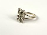 a close up of a diamond ring on a white surface