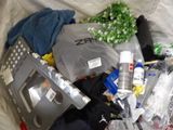 a pile of items in a plastic bag on a bed