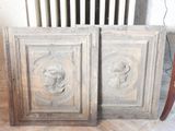 pair of antique carved wood doors with carved faces on them