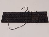 a black keyboard and mouse sitting on a white table