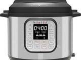 a close up of an electric pressure cooker on a white background