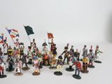 a lot of figurines that are on a white surface