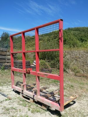 a red fence that has a bunch of items in it
