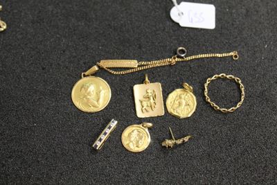 a close up of a bunch of gold jewelry on a table
