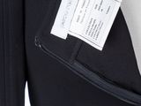 a close up of a black jacket with a white label on it