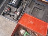 a box of tools sitting on the floor next to a box of tools