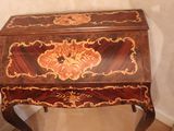 a small wooden desk with a floral design on it