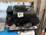 a black suitcase sitting on top of a blue table