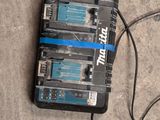 two batteries connected to a charger on the ground