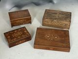 three small wooden boxes sitting on top of a table next to each other