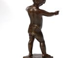 a bronze statue of a boy pointing at something on a white background