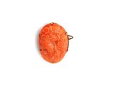 an image of a carved coral pendant on a white background
