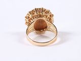 an image of a gold ring with a brown stone in it