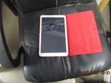 an image of a cell phone sitting on a leather chair