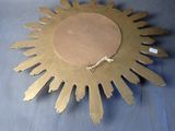 a gold sunburst on a blue table cloth