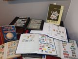 a table with a lot of stamps and books on it