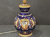 a blue and gold vase with a lion on it