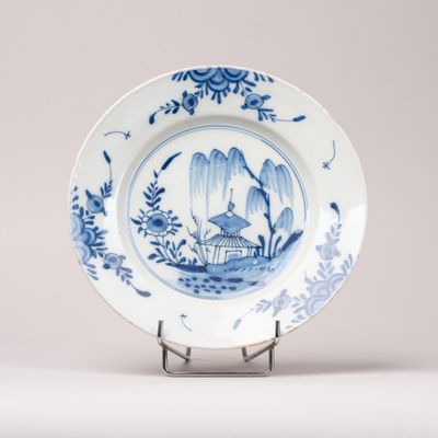 a blue and white plate with a bird on it