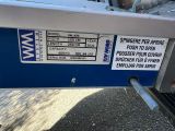 a sign on the back of a boat that is parked on the side of the road
