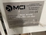 a label on the side of a machine that is sitting on a table