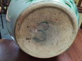a close up of a vase on a table