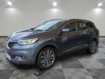 a blue suv parked in a garage with a checkered floor