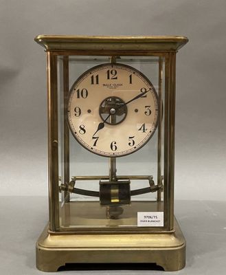 a gold clock that is sitting on a table