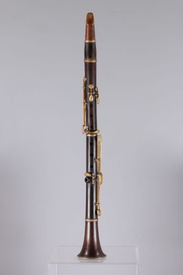 a close up of a bassoon on a clear stand