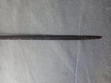 a close up of a metal object on a mesh surface