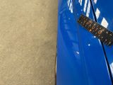 a remote control on the side of a blue car