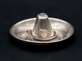 a silver plate with a silver cone on top of it