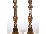 a pair of brass candlesticks on marble bases
