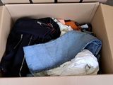 a cardboard box filled with clothes and a pair of jeans