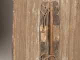 an old piece of wood with a metal latch on it
