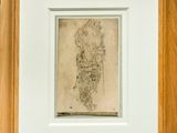 a framed drawing of a man standing in front of a white wall
